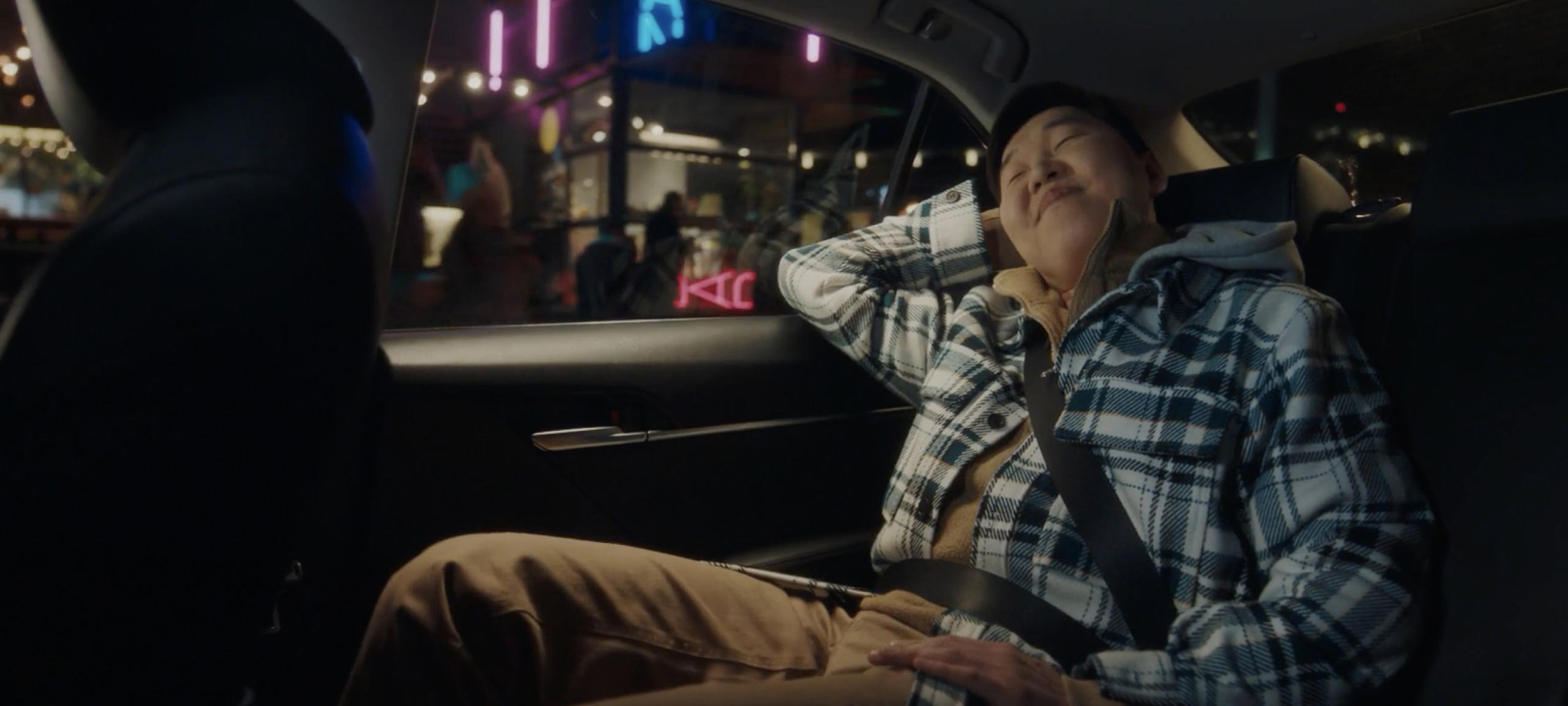 Passenger relaxing in the back of a Comfort car